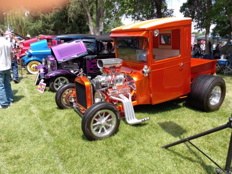 Unique orange classic truck with a powerful engine and custom modifications.