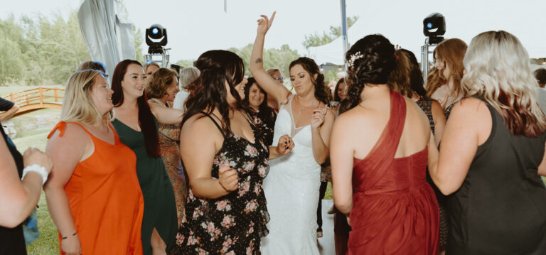 Wedding reception celebration at A & B Productions event, featuring guests dancing and socializing o.