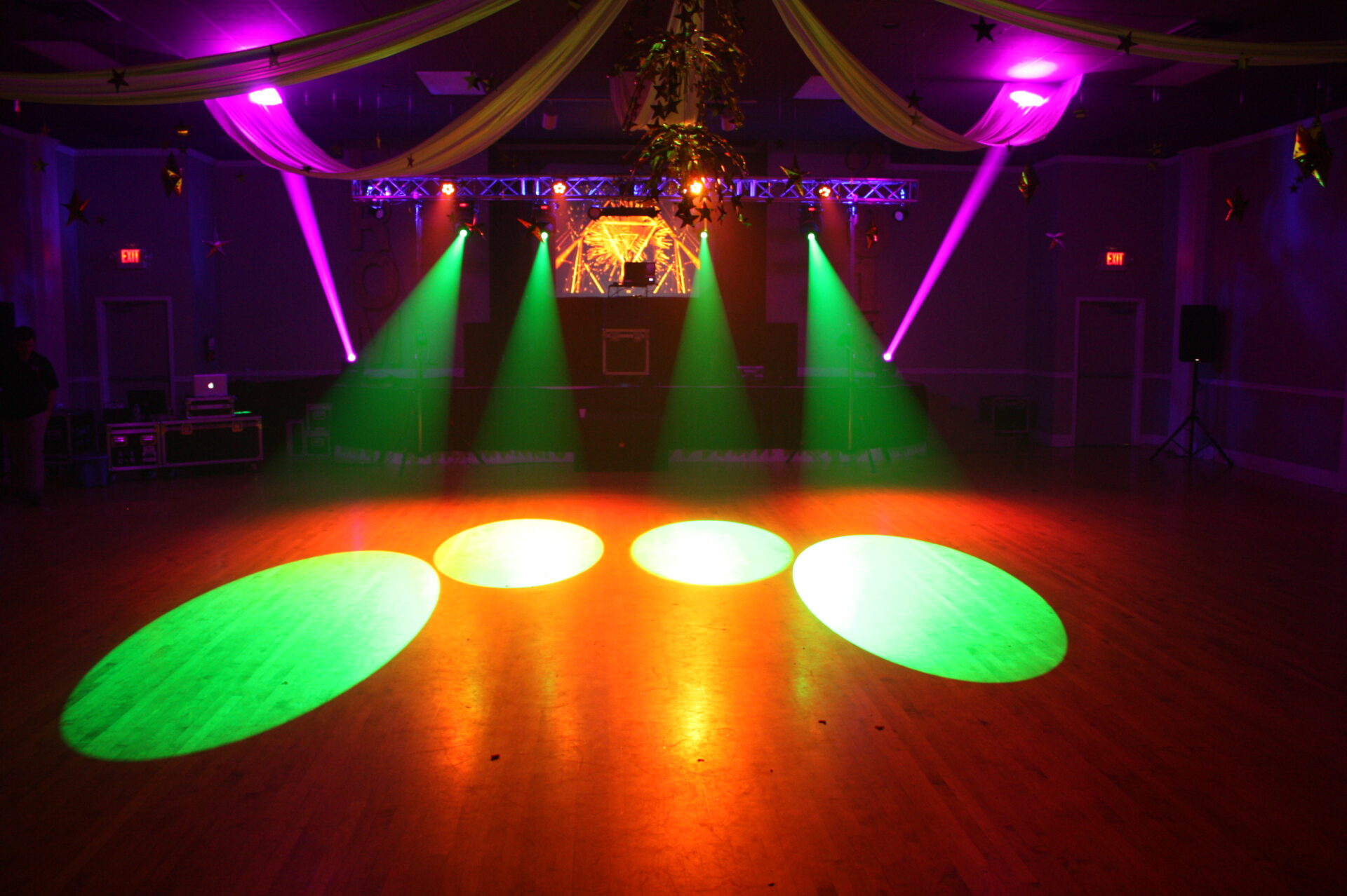 Event lighting with colorful spotlights and dance floor effects at A & B Productions.