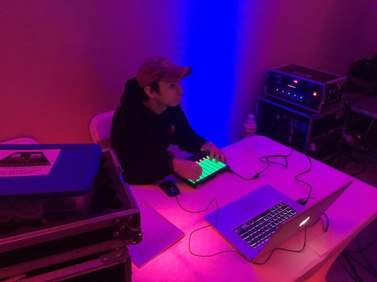 DJ performing with lighting and sound equipment at A & B Productions.