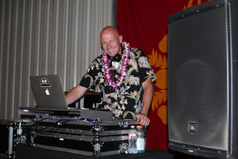 DJ mixing at A & B Productions event with professional equipment and lively atmosphere.