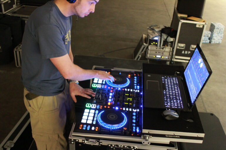 DJ mixing console with laptop at A & B Productions event setup.