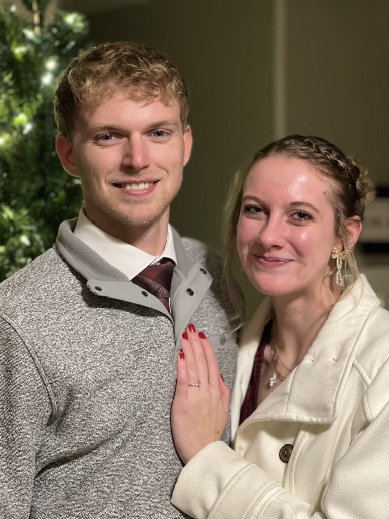 Happy couple celebrating Christmas together indoors.