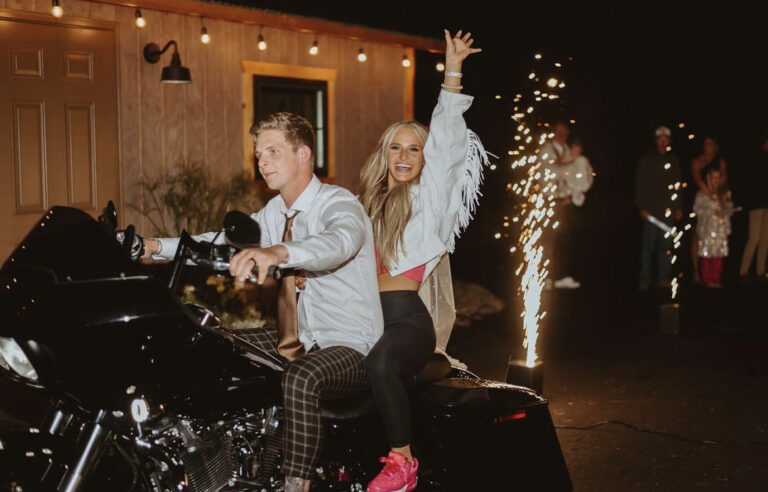 A lively celebration with people enjoying a motorcycle ride and fireworks display.