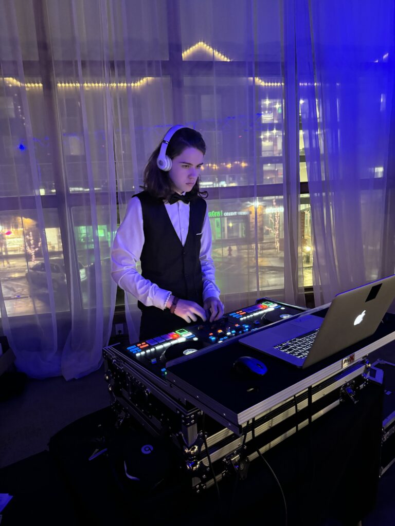 DJ girl mixing music with professional equipment at A & B Productions event.