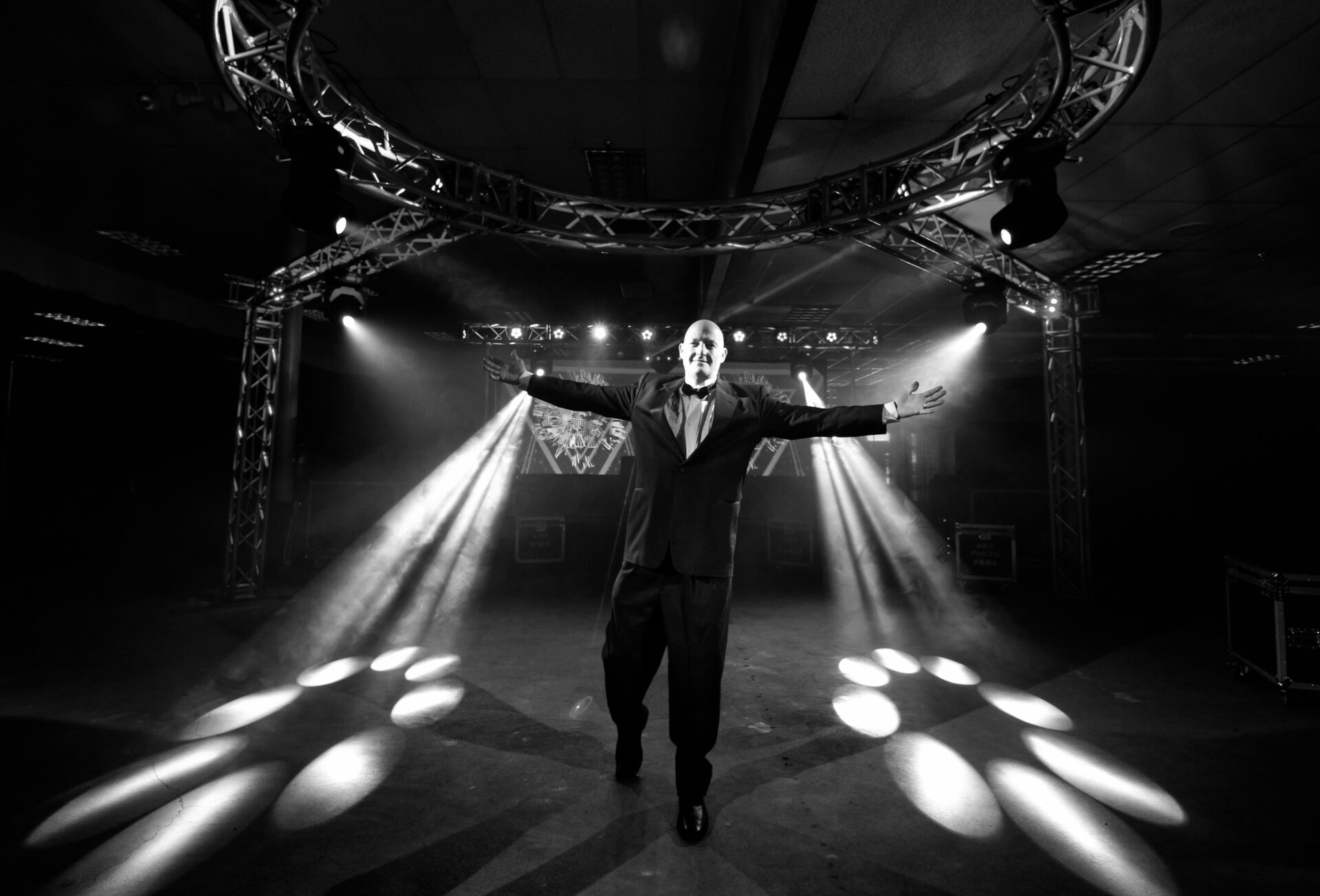 A & B Productions stage show with a performer in a tuxedo under dramatic lighting.