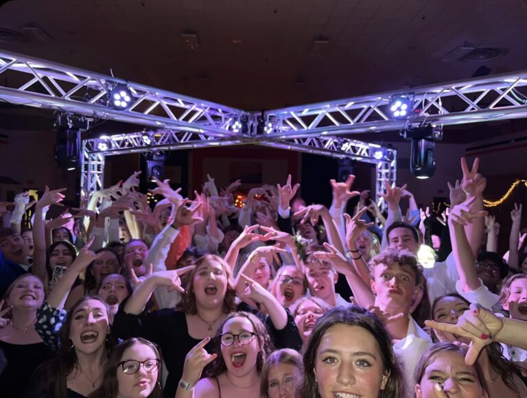Stage lighting and energetic crowd at a youth dance event.