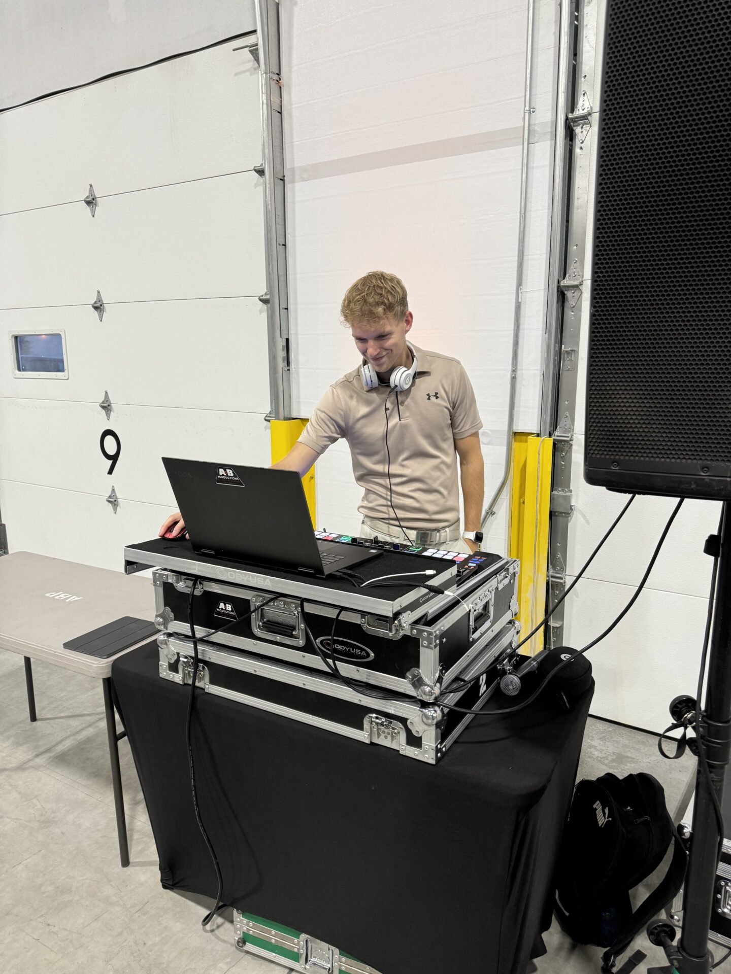 DJ mixing music at A & B Productions event, showcasing professional DJ equipment and sound system