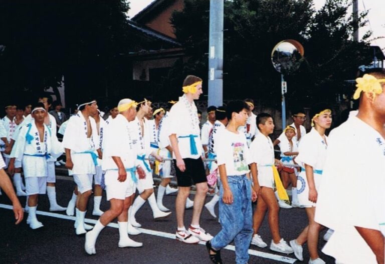 Group of children and teens participating in a traditional Japanese festival parade