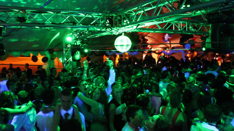 Vibrant dance floor illuminated with colorful lighting at A & B Productions event.