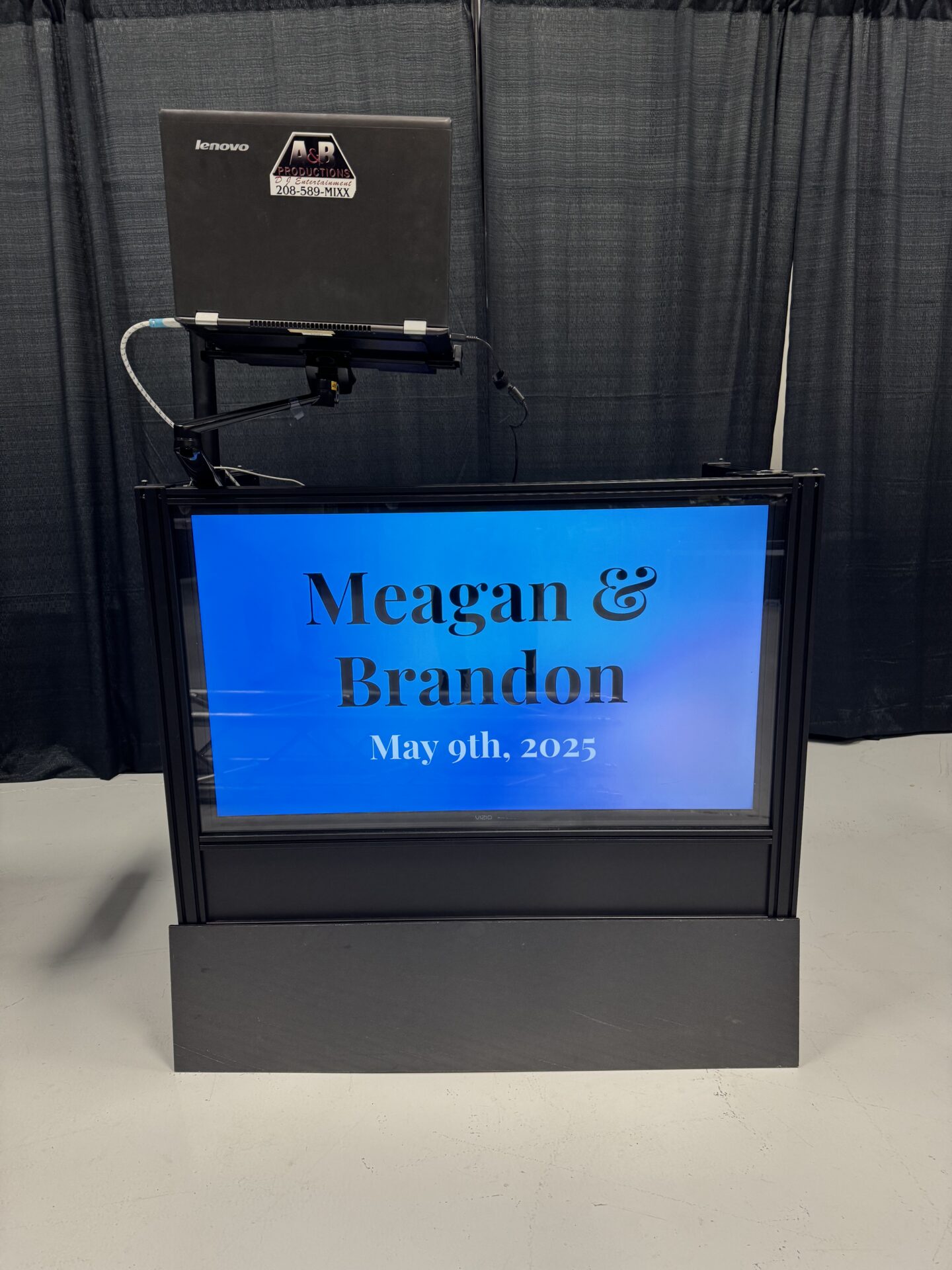 Digital event display screen with names and date for wedding or celebration.