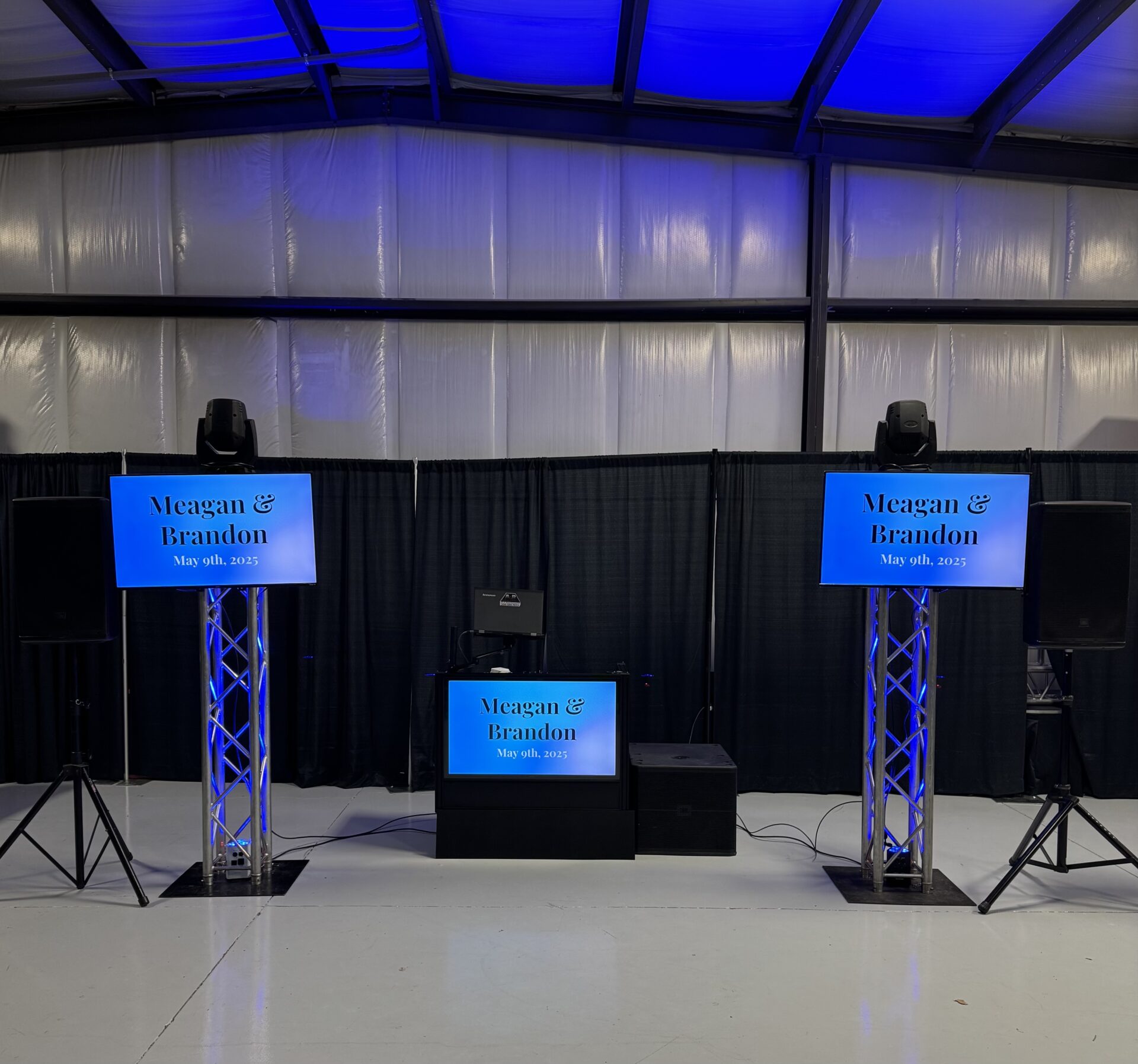 Professional event stage with LED screens and sound equipment for weddings and celebrations.
