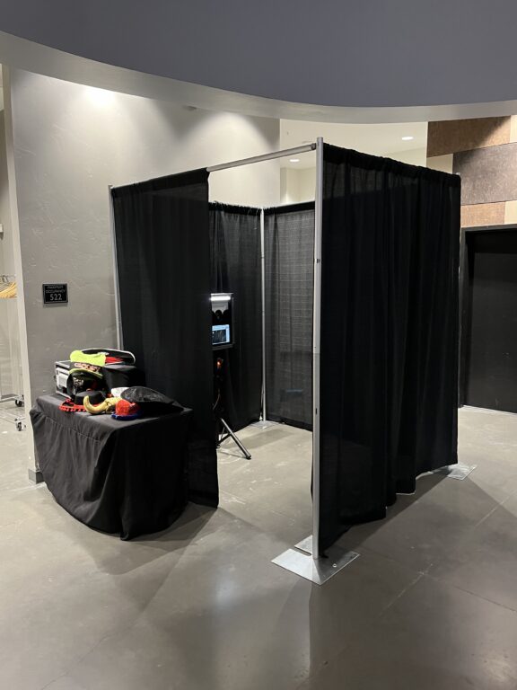 Photo booth setup with black curtains for events by A & B Productions.
