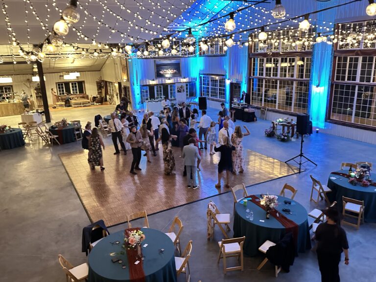 Event venue with dance floor and lighting for weddings and parties.