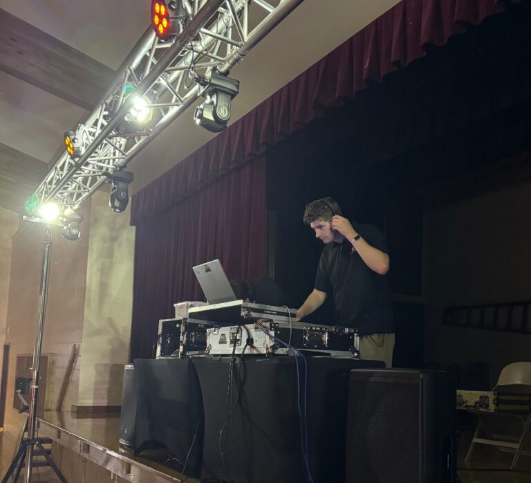 DJ mixing music at A & B Productions event.