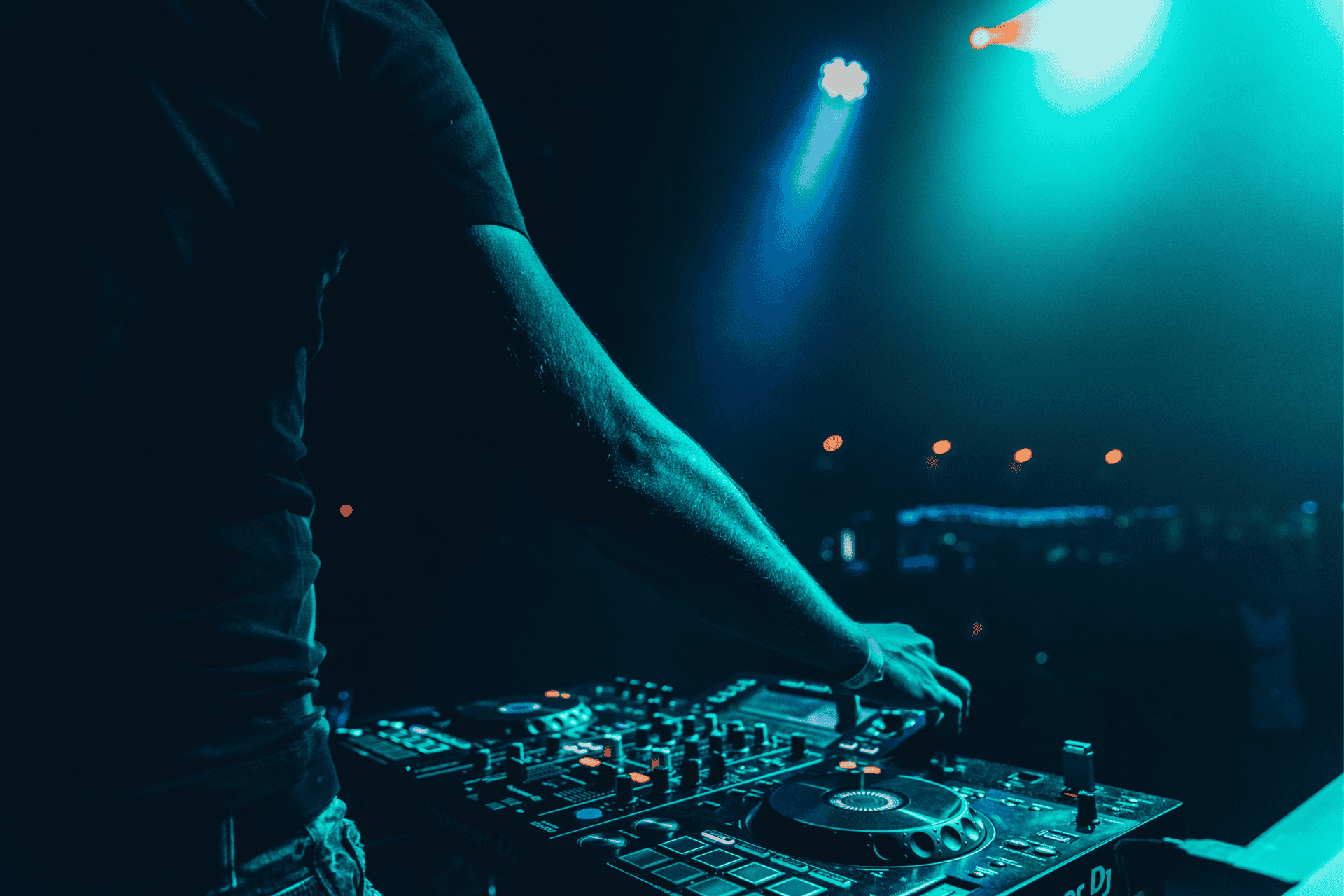 DJ mixing music on professional equipment at A & B Productions event.
