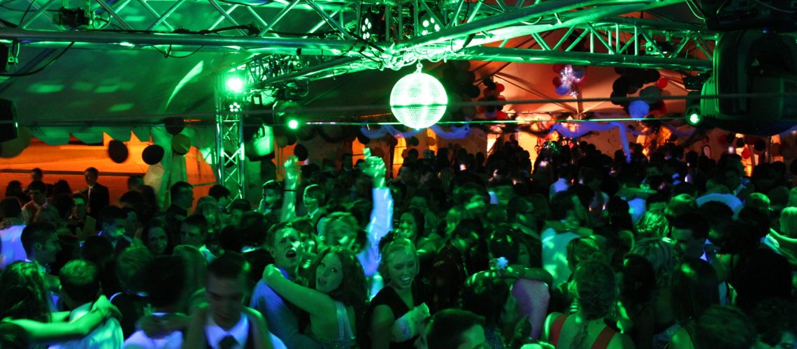 Vibrant dance floor illuminated with colorful lighting at A & B Productions event.
