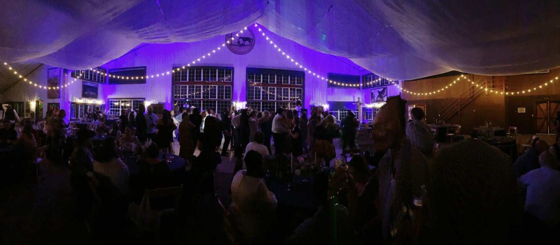 Event lighting setup with vibrant purple and warm yellow string lights at A & B Productions.