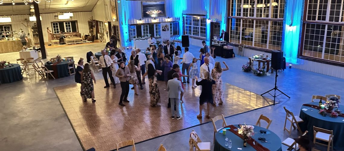 Event venue with dance floor and lighting for weddings and parties.