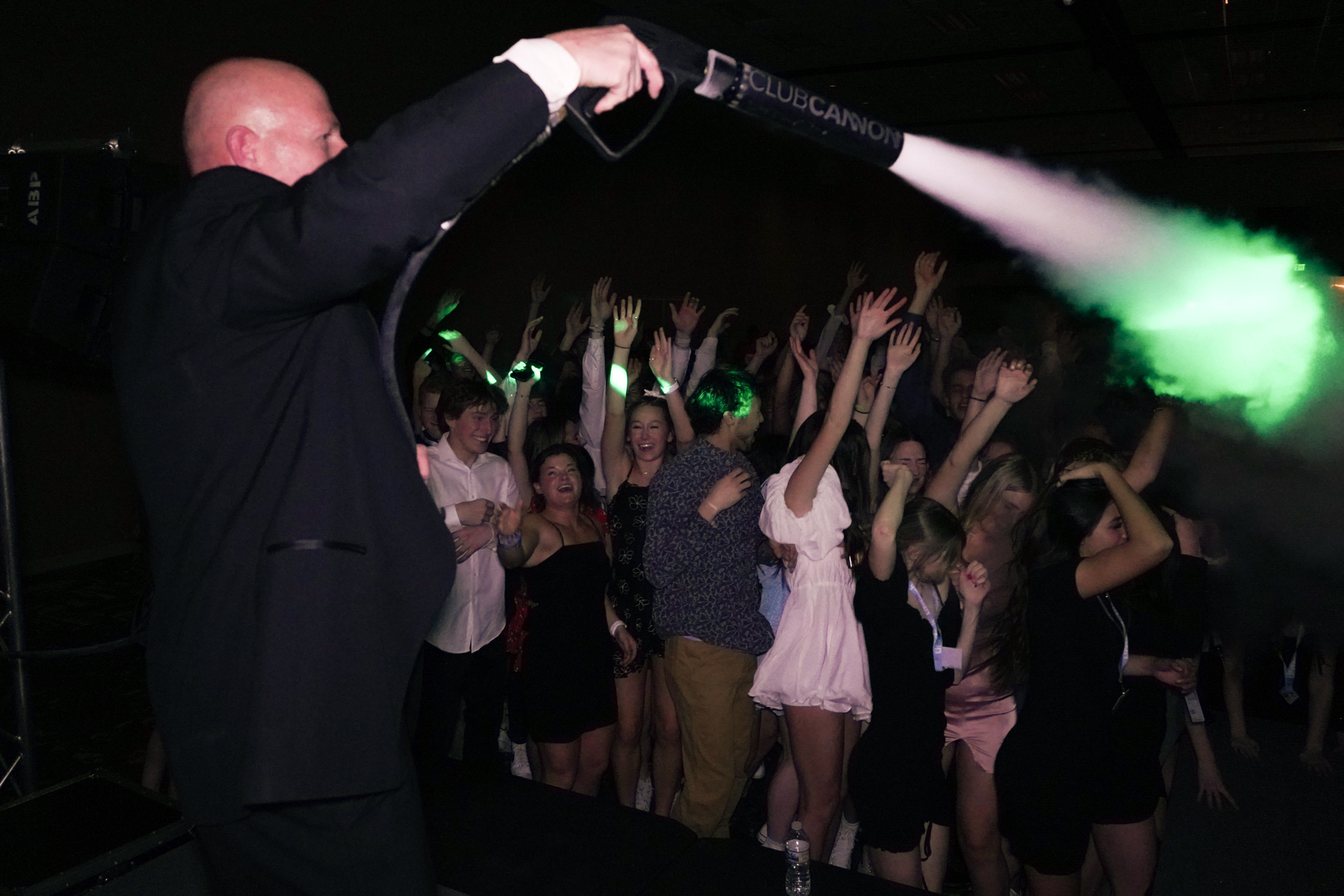 DJ firing a CO2 blast over a packed college dance floor