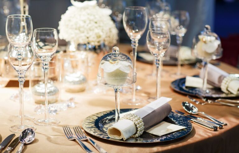 Beautiful wedding table setup featuring glassware, floral arrangements, and sophisticated tableware.