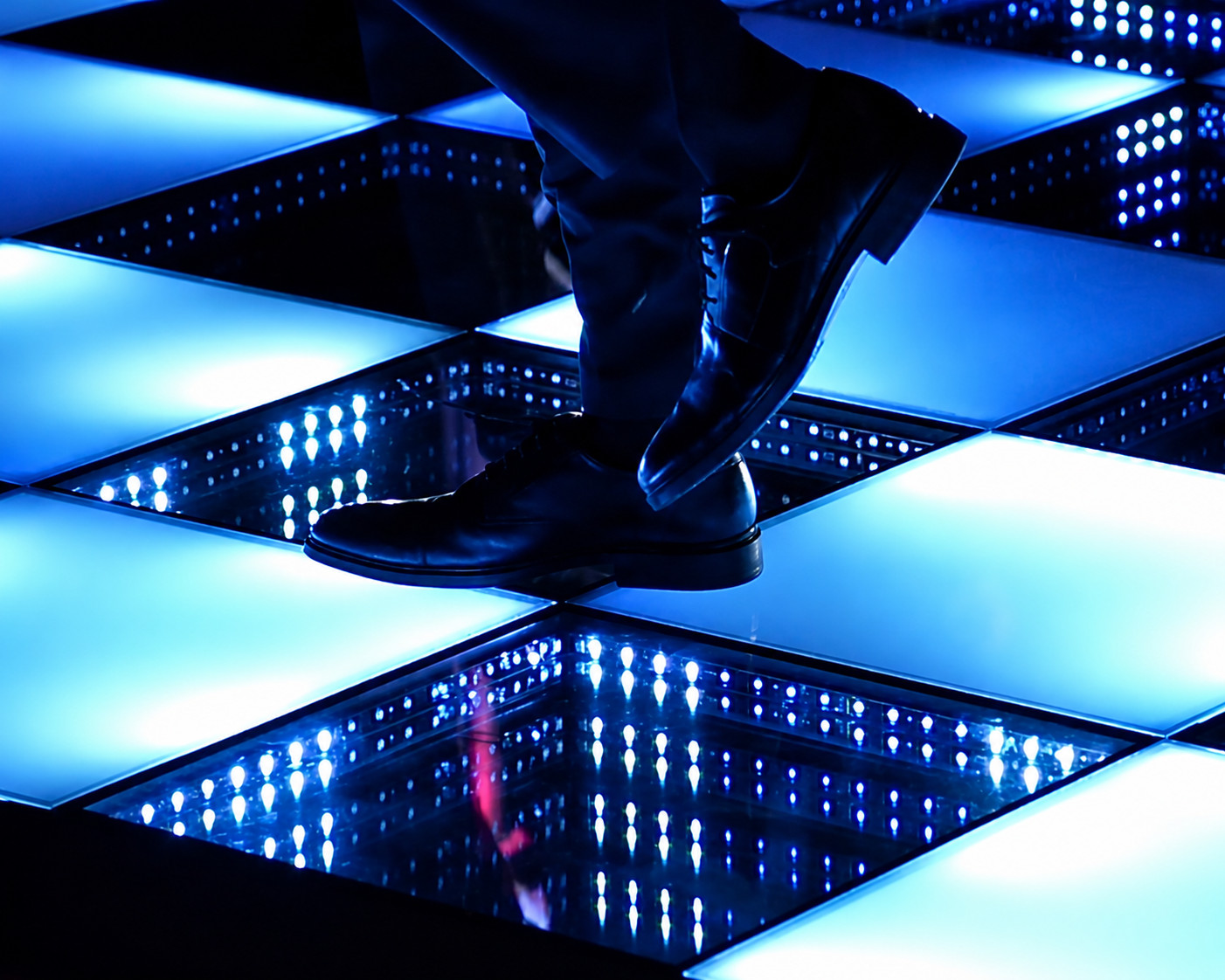 Dancers' shoes on a glowing LED dance floor at an A&B Productions event